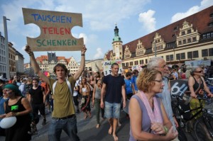 Manifestantes del decrecimiento en una marcha por las calles de Leipzig, en septiembre. El cartel dice: intercambia, comparte, da. Crédito: Klimagerechtigkeit Leipzig (http://klimagerechtigkeit.blogsport.de/)
