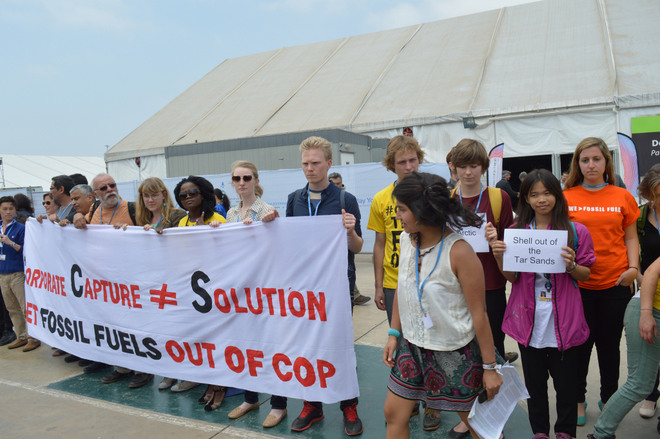 Un grupo de activistas protesta ante el lugar de un evento organizado por Shell, la gigante petrolera angloholandesa, en las instalaciones de la COP 20, en la capital peruana. Crédito: Adopt a Negotiator