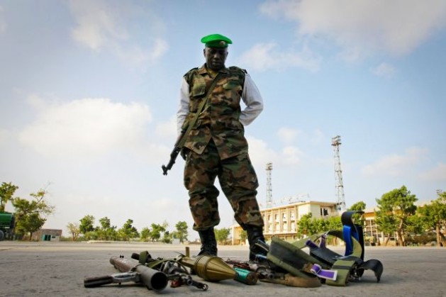 Un soldado junto a las armas incautadas a cuatro presuntos miembros de Al Shabaab, un grupo insurgente islámico, en Mogadiscio, Somalia. Los combatientes tenían en su poder una granada propulsada por cohete, dos metralletas y 84 rondas de municiones. Crédito: Foto de la ONU/Stuart Price