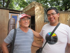 Néstor Colman, un decano de los afectados por las crecidas del río Paraguay, en el Bañado Sur, en Asunción, al lado de Cleto Pérez, fundador del Movimiento 1811 que organiza las luchas de los bañadenses. Detrás el pequeño comercio de Colman en uno de los improvisados refugios de los expulsados por las aguas en la capital de Paraguay. Crédito: Mario Osava/IPS