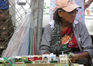 Una vendedora callejera en Manila ofrece paquetes de 20 cigarrillos a menos de un dólar. Crédito:Kara Santos/IPS.