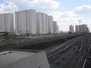Los edificios crecen como hongos en Samambaia, la segunda ciudad por población del entorno de Brasilia, cuyo aumento es de unas 10.000 personas cada año, un ritmo de al menos cuatro por ciento. A la izquierda, los rieles del metro del Distrito Federal capitalino, con una capacidad muy superior a su uso. Crédito: Mario Osava/IPS