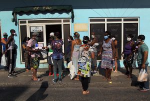 Un grupo de clientes, protegidos con mascarillas y tratando de mantener la distancia entre ellos, aguarda su turno fuera de un establecimiento estatal para la compra de alimentos, en el municipio de Plaza de Revolución, en La Habana, en Cuba. Foto: Jorge Luis Baños/IPS