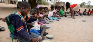 Escolares mientras toman una merienda en una escuela rural de Mozambique. En los sectores pobres de muchos países, la comida en las escuelas es su principal o única fuente de nutrición diaria, porque sus familias no tienen como alimentarlos. Foto: Unicef/UN051605/Rich